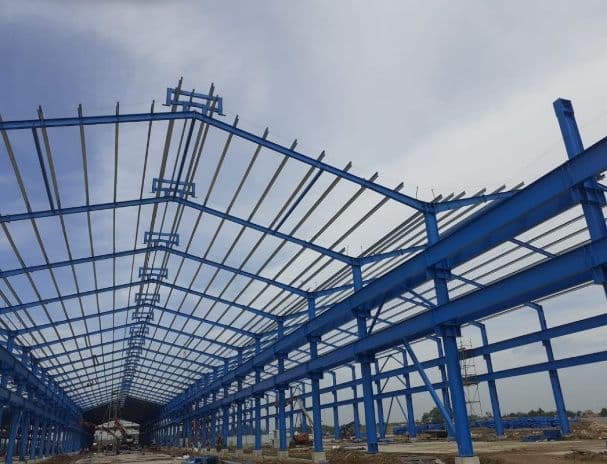 Blue steel portal frame of a warehouse under construction