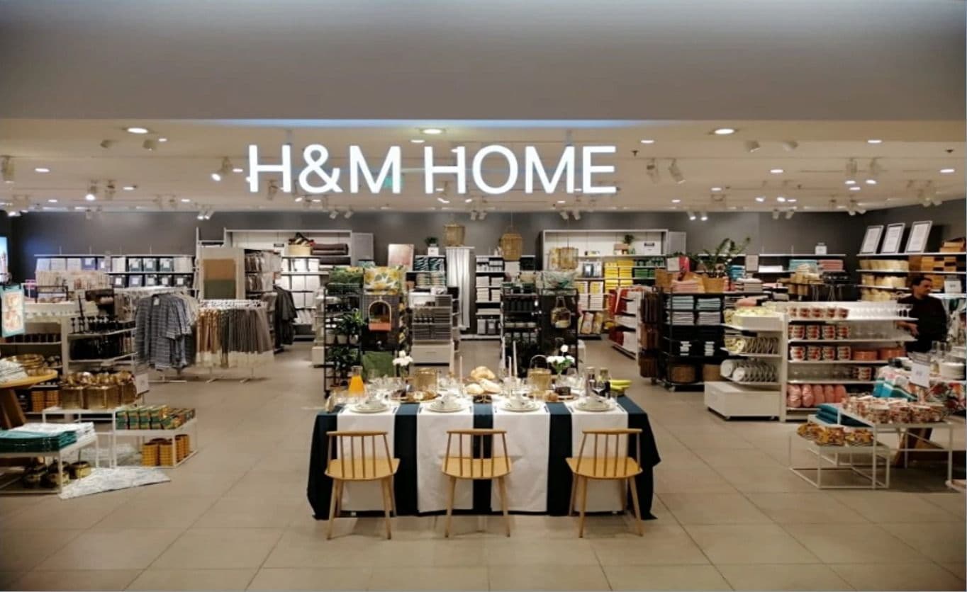 H&M Home department with dining displays beneath illuminated signage